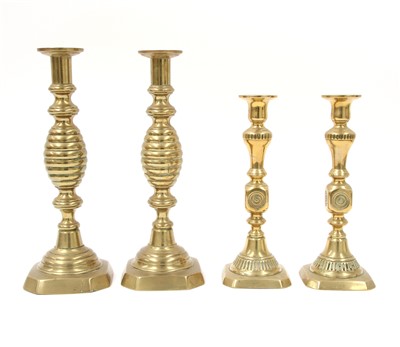 Lot 328 - Two pairs of brass open twist candlesticks