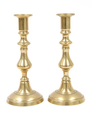 Lot 323 - Four pairs of brass candlesticks