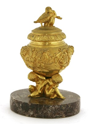 Lot 192 - An ormolu inkwell, cover and liner