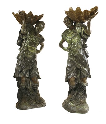 Lot 22 - A pair of life-sized green patinated bronze blackamoors