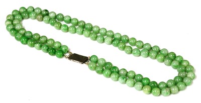 Lot 87 - A two row uniform jadeite bead necklace
