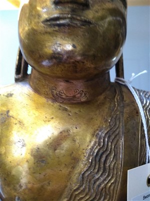Lot 564 - A gilt bronze figure of Buddha