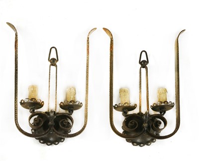 Lot 195 - A pair of French iron twin-branch wall lights