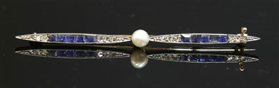 Lot 160 - An Art Deco gold and platinum pearl, sapphire and diamond propeller form bar brooch, c.1920