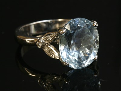 Lot 438 - An 18ct white gold single stone aquamarine ring with diamond set shoulders