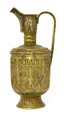 Lot 490 - A Persian brass inlaid spouted ewer