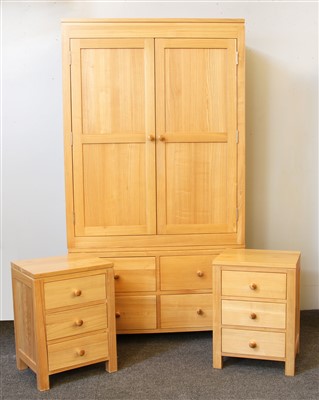 Lot 522 - A modern oak wardrobe with two cupboard doors over four drawers