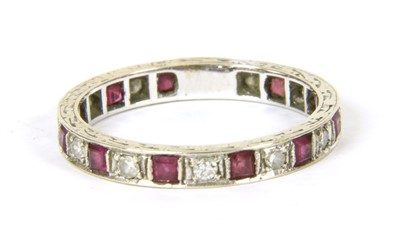Lot 12 - A white gold ruby and diamond eternity ring