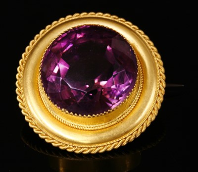 Lot 39 - A Victorian gold shield form single stone amethyst brooch