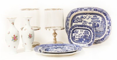 Lot 313 - A set of four graduated pottery blue and white willow pattern plates