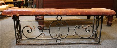 Lot 479 - A wrought iron and leather upholstered club fender
