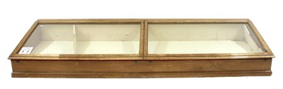 Lot 487 - A glazed oak museum table top display cabinet