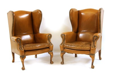 Lot 488 - A pair of tan leather wingback armchairs