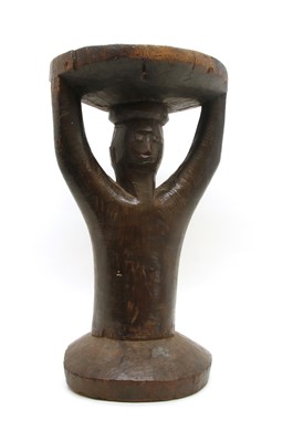 Lot 258 - A Southern African carved hardwood figural stool