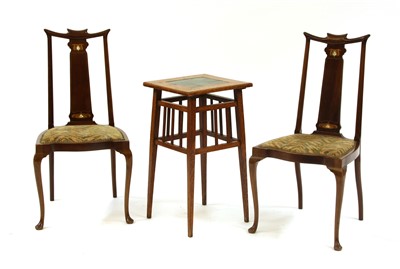 Lot 557 - An Art Nouveau oak and tile top occasional table