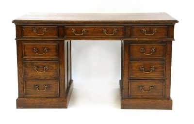 Lot 560 - An eighteen drawer oak partners desk