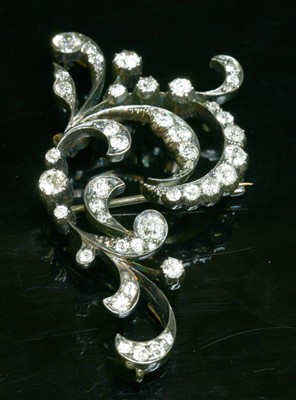 Lot 65 - A Victorian diamond set scroll brooch