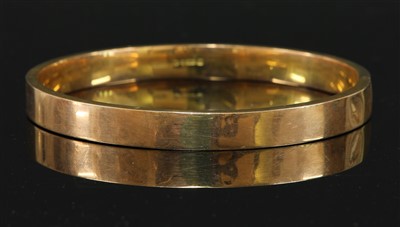 Lot 112 - A 9ct gold flat section hollow slave bangle