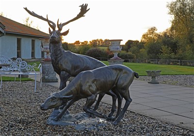 Lot 939 - A large bronze figure group of a stag and a doe