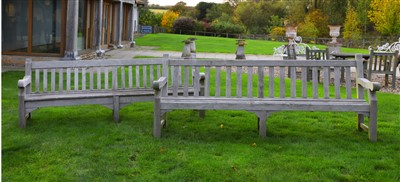 Lot 947 - A pair of large teak slatted garden seats