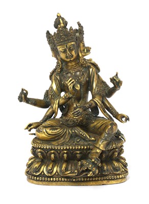 Lot 122 - A Tibetan gilt bronze bodhisattva
