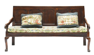 Lot 669 - A George III oak settle