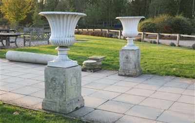 Lot 933 - A pair of painted iron urns