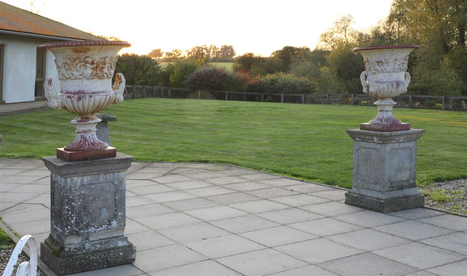 Lot 940 - A pair of cast iron urns