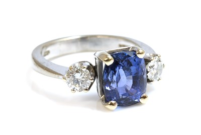 Lot 289 - An 18ct white gold three stone sapphire and diamond ring