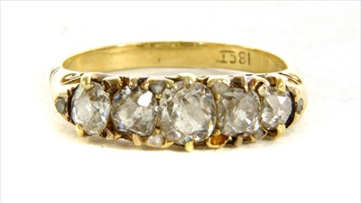 Lot 6 - A Victorian five stone diamond carved head ring