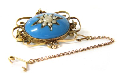Lot 91 - An enamel and split pearl brooch