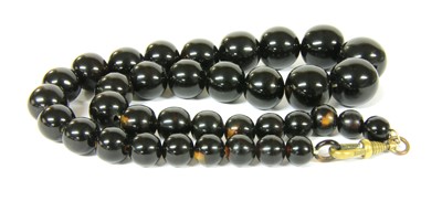 Lot 12 - A single row graduated round tortoiseshell bead necklace