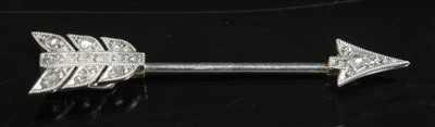 Lot 195 - An Art Deco gold and platinum, diamond set arrow pin or jabot, c. 1925