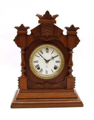 Lot 352 - A Victorian walnut striking mantle clock