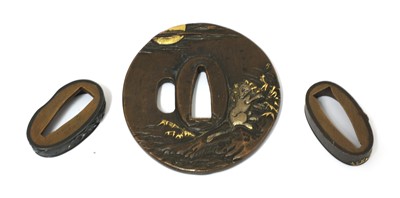 Lot 215 - A Japanese shakudo tsuba