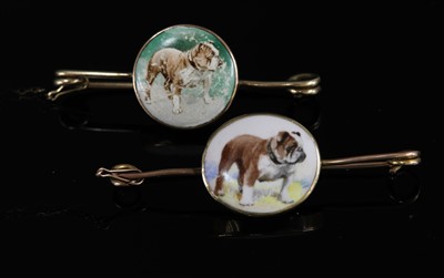 Lot 109 - Two painted ceramic plaque brooches