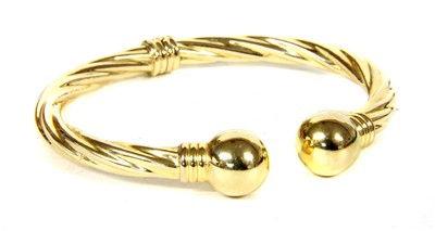 Lot 67 - An Italian 9ct gold hinged torque bangle