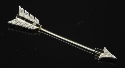 Lot 194 - An Art Deco arrow form diamond and black paste set jabot, c.1925