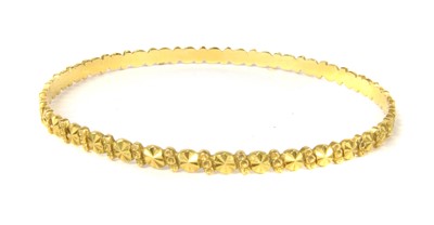 Lot 330 - A high carat gold flat section slave bangle