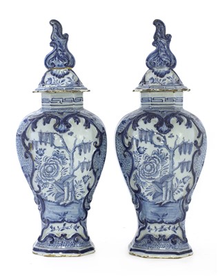 Lot 272 - A pair of Dutch delft vases and covers