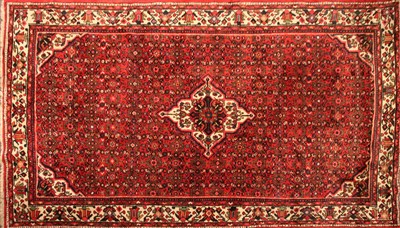 Lot 525 - A red ground Persian rug
