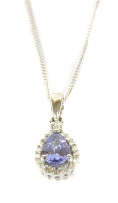 Lot 1061 - A 9ct white gold tanzanite and diamond cluster pendant
