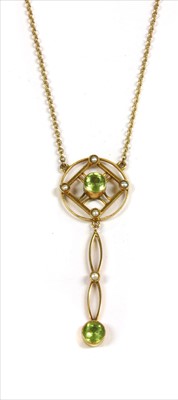 Lot 20 - An Edwardian gold peridot and split pearl pendant