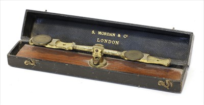 Lot 1178 - A brass equal arm sovereign rocker