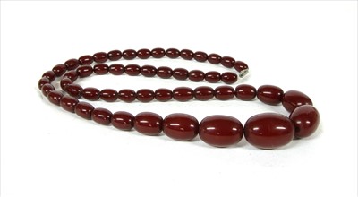 Lot 69 - A single row graduated cherry coloured olive shaped Bakelite bead necklace