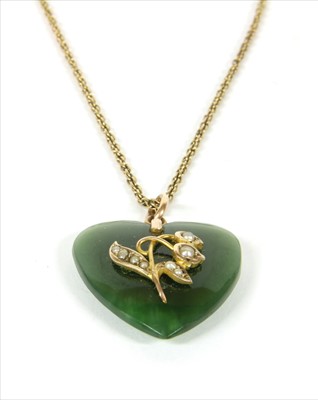 Lot 22 - A nephrite jade and split pearl pendant