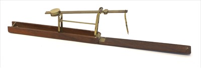 Lot 1036 - A mahogany cased brass folding coin scale