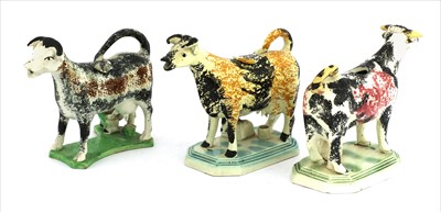 Lot 13 - Three Staffordshire cow creamers