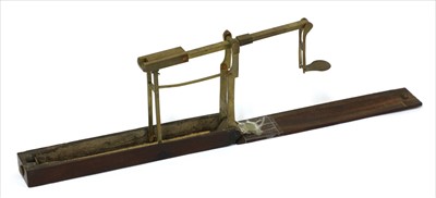 Lot 1057 - A mahogany cased brass folding coin scale