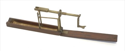 Lot 1076 - A mahogany cased brass folding coin scale